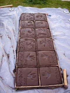 Home made paving stones. Take those imprints with you when you move! A great alternative to doing them in a patio or driveway.