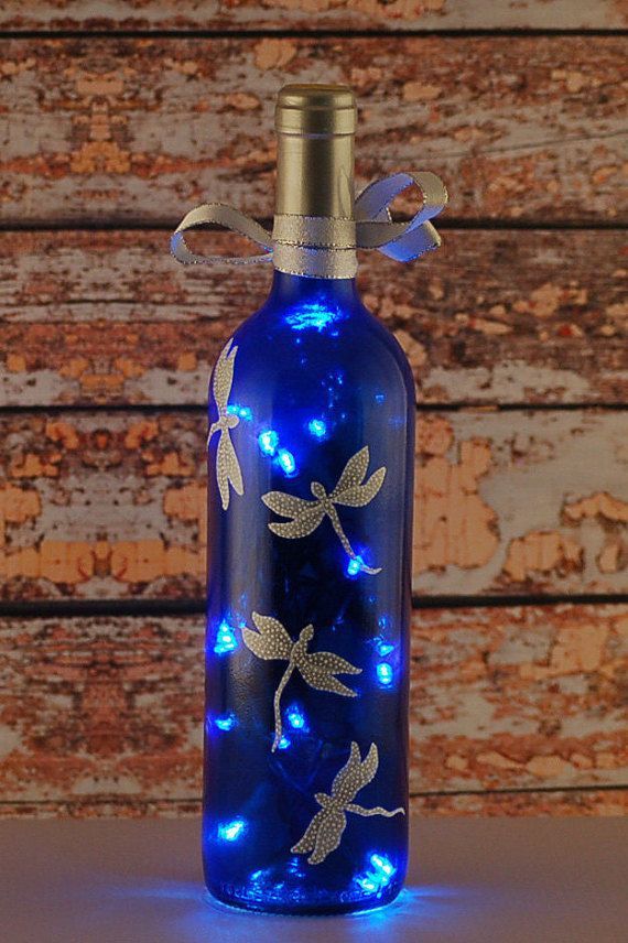 Blue and white dragonfly wine bottle lamp. An empty clear wine bottle was reclaimed and repurposed into this wine bottle light.