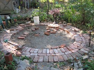 Circular brick patio area. I like how she altered the circles of brick in a perpendicular pattern too.