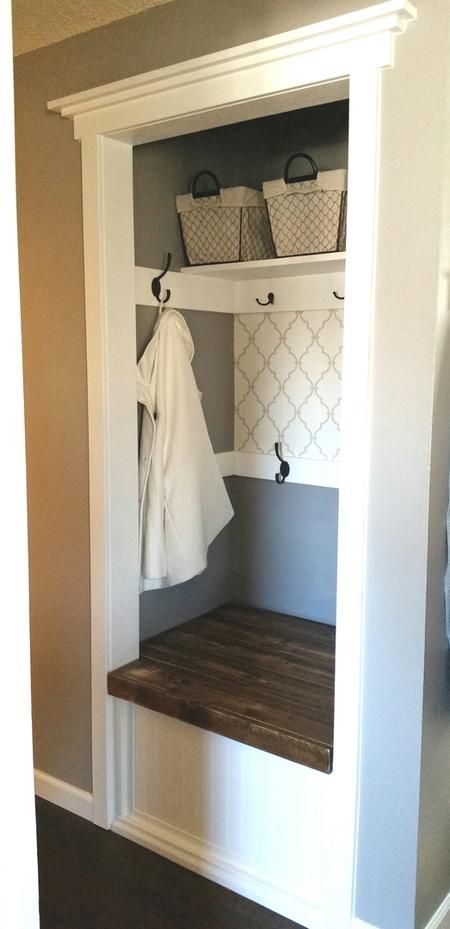 Hallway Closet Makeover DIY with a bench seat that opens for storage! Grey and white, coat hooks.
