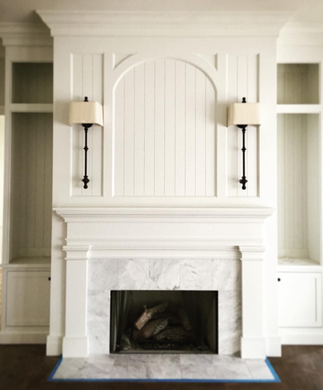 Love the arch and sconces. Would do brick instead of marble surround