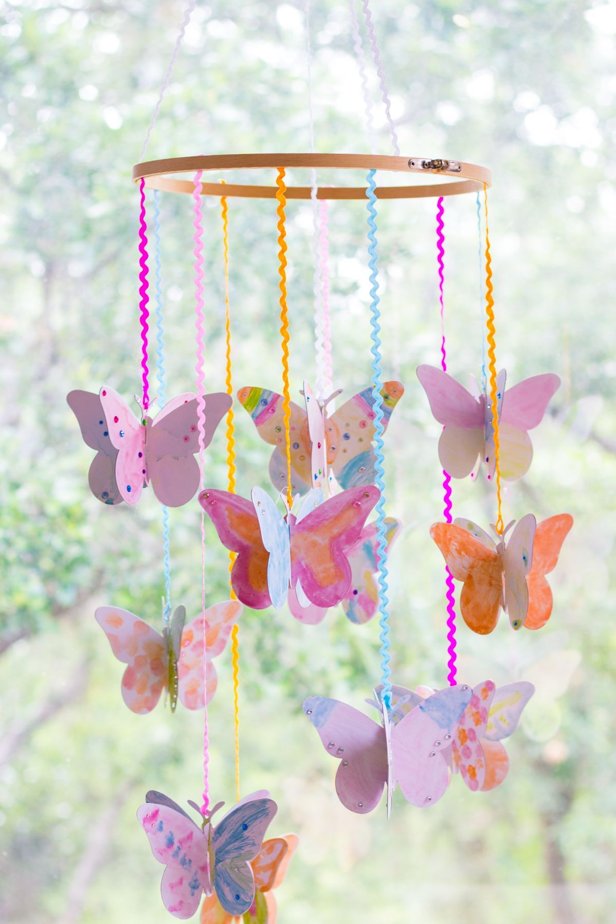 Make a DIY watercolor butterfly mobile – such a fun kids craft idea!