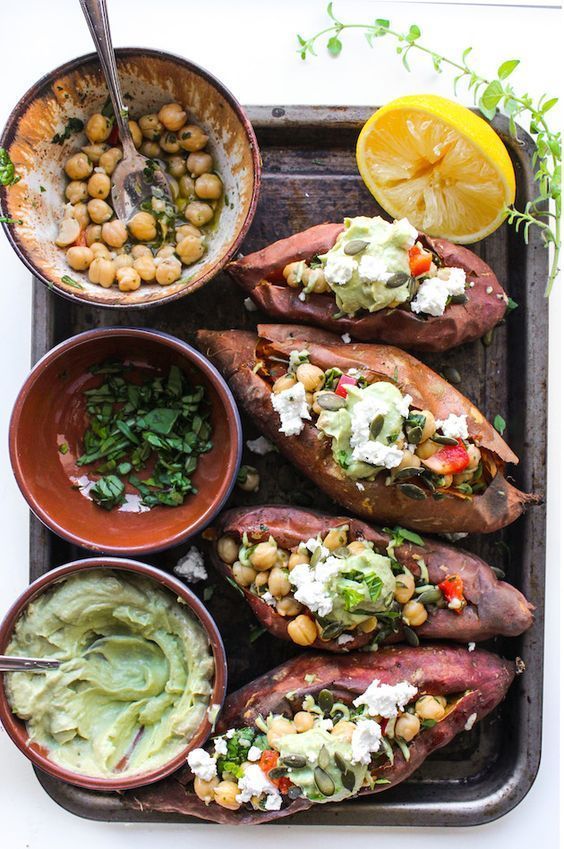 Mediterranean stuffed sweet potatoes with marinated chickpeas and topped with an avocado tahini sauce – grain free & vegan