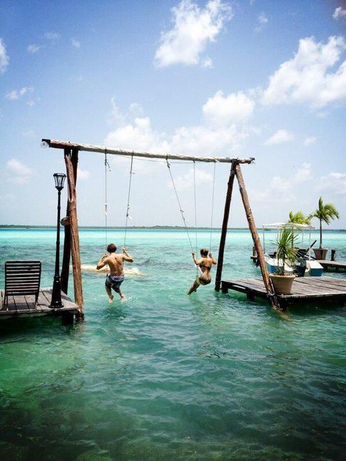 Puerto Costa Maya, Mexico. Swing over the Lake of Seven Colors on a double sea swing. Because of the multiple shades of blue, the