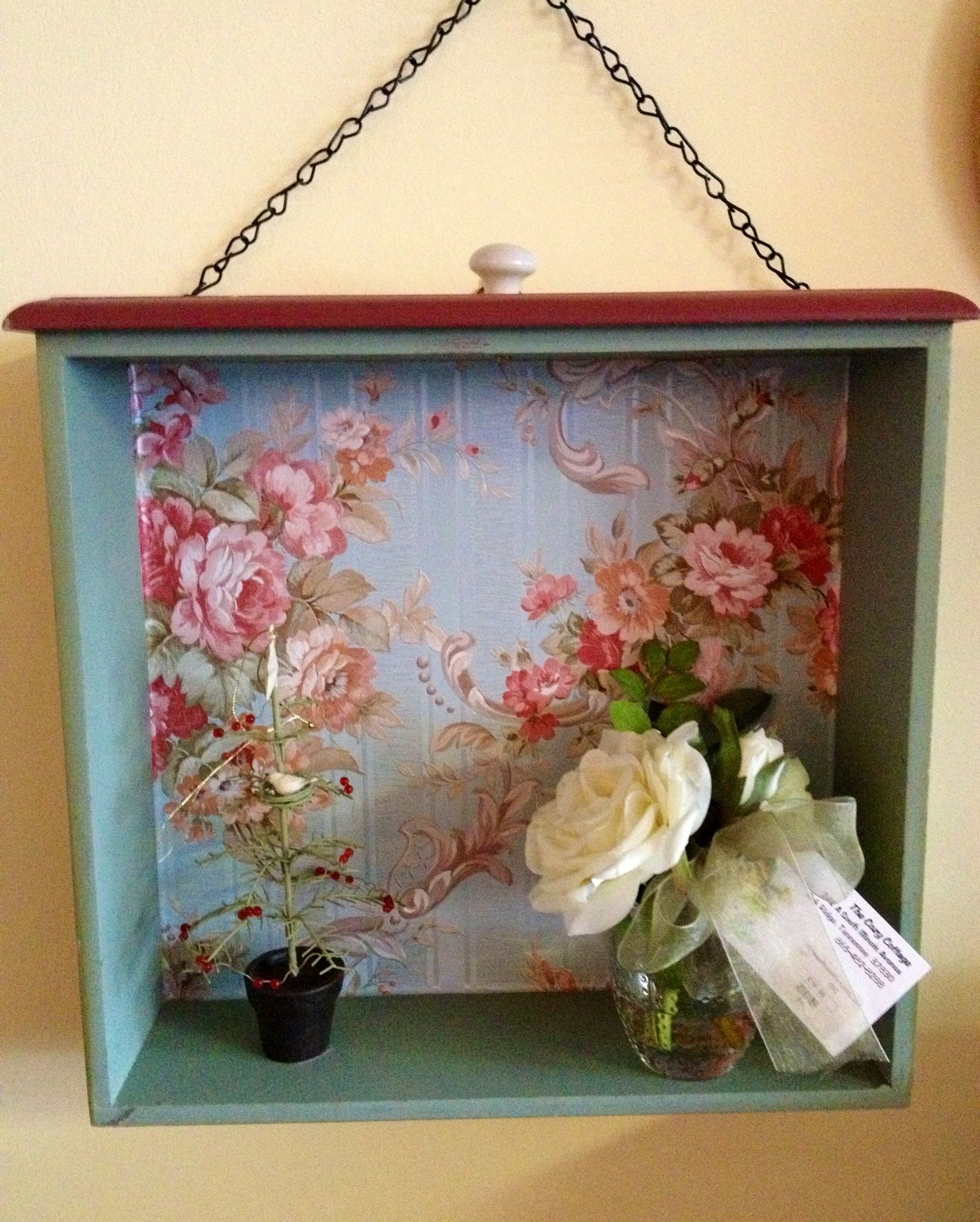 Recycled old drawer with wallpaper.
