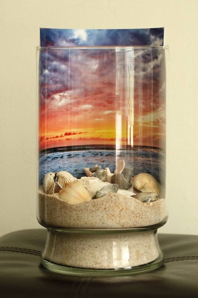 Sand and sea shells against a sunrise backdrop; in a jar. DIY
