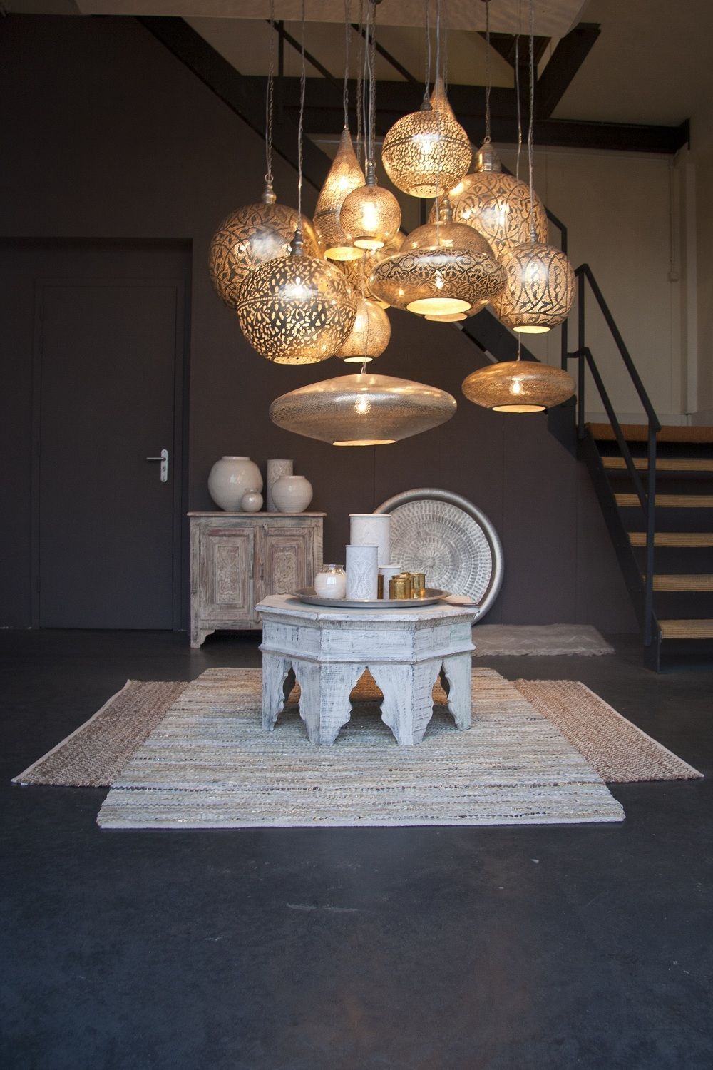This impressive image shows a selection of the pendant lights, furniture and rugs from Zenza.