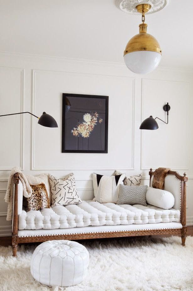 I love the antique gold light fixture paired with the tufted couch. The white fur carpet brings the whole room together with that