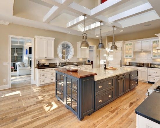 Just beautiful! Hickory wood flooring keeps it light and bright in this kitchen. & love the contrast of the blue island.