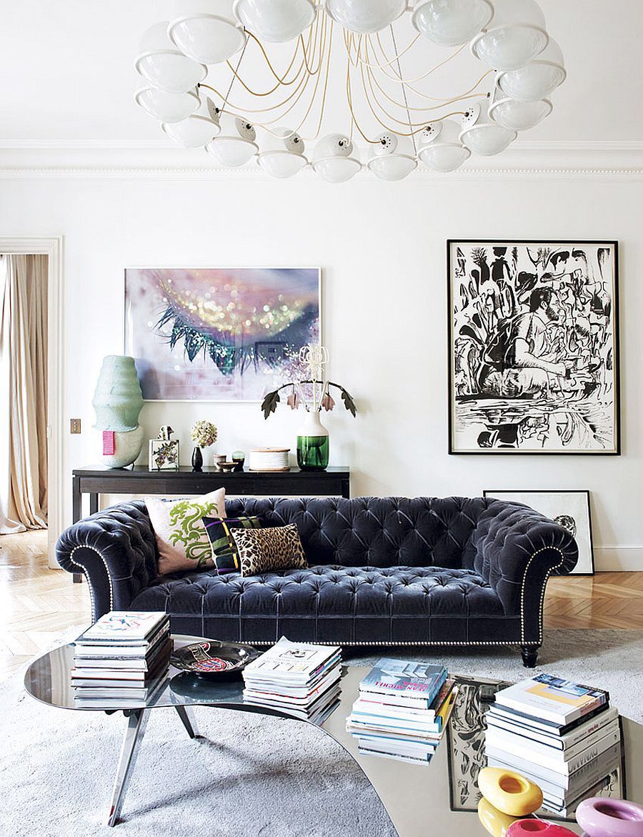 Large tufted velvet sofa with modern chandelier in French-inspired living room #asian_eclectic_decor