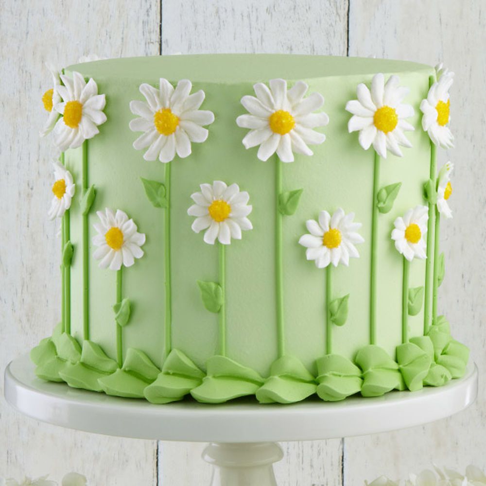 Our favorite fresh-look flower, the daisy forms a fun covering for the sides of this cake. The  centers are dusted with yellow