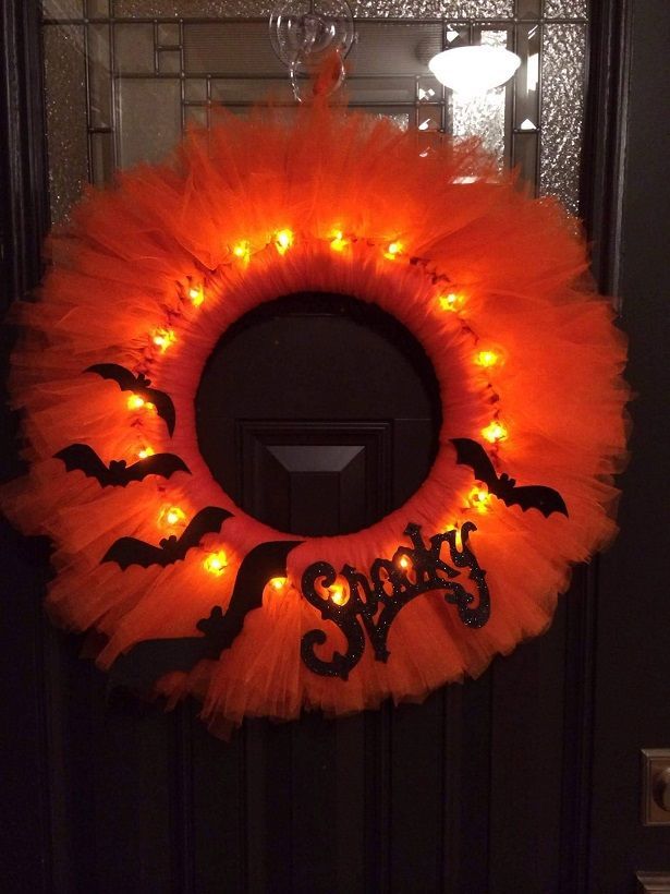 Supplies Needed: Styrofoam Wreath Battery operated lights Orange tulle Bat/spooky decoration (found at craft stores) Pins/glue