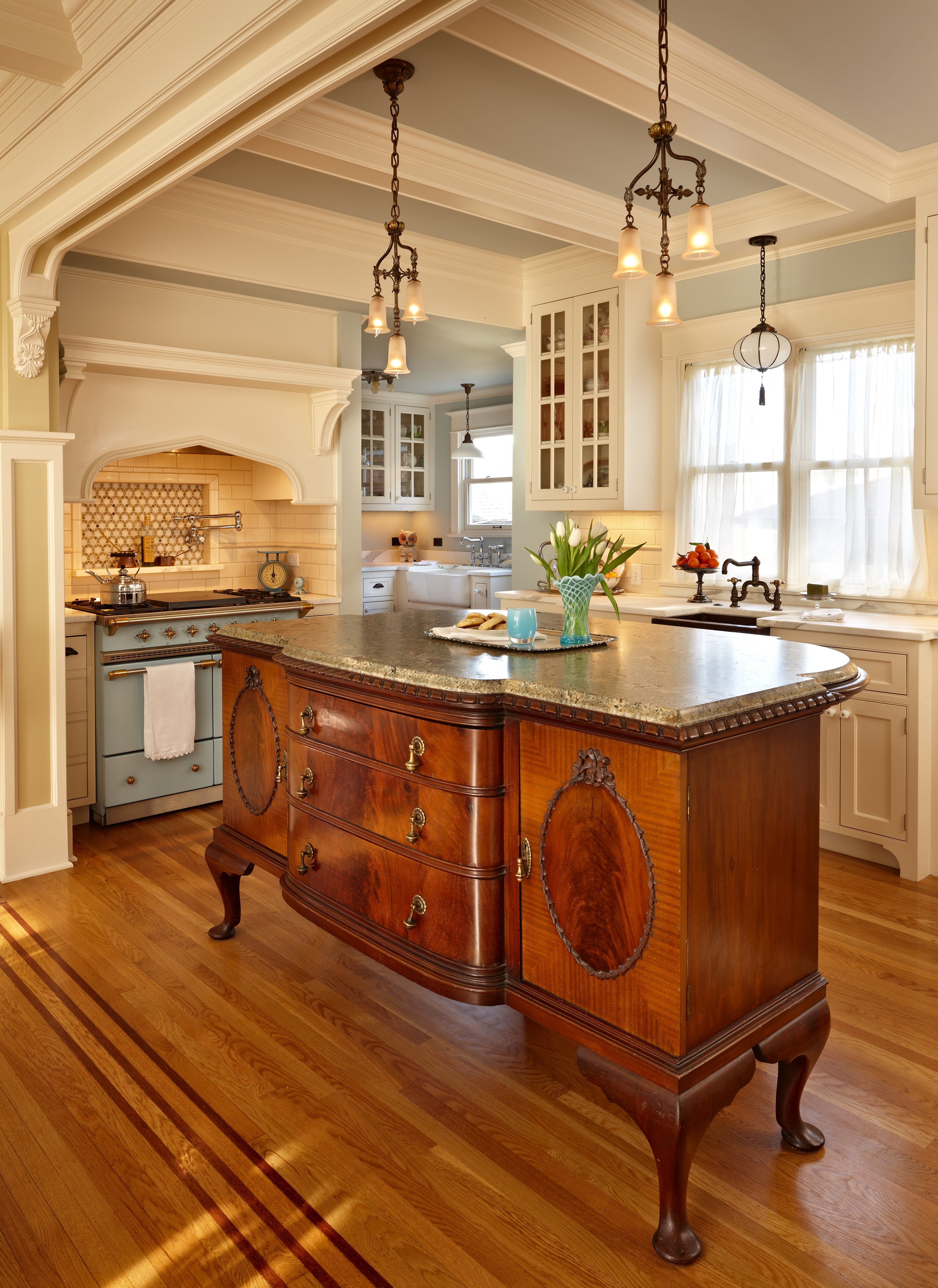 The centerpiece of the kitchen is an antique French cabinet expanded at its back and topped with a granite counter to form an