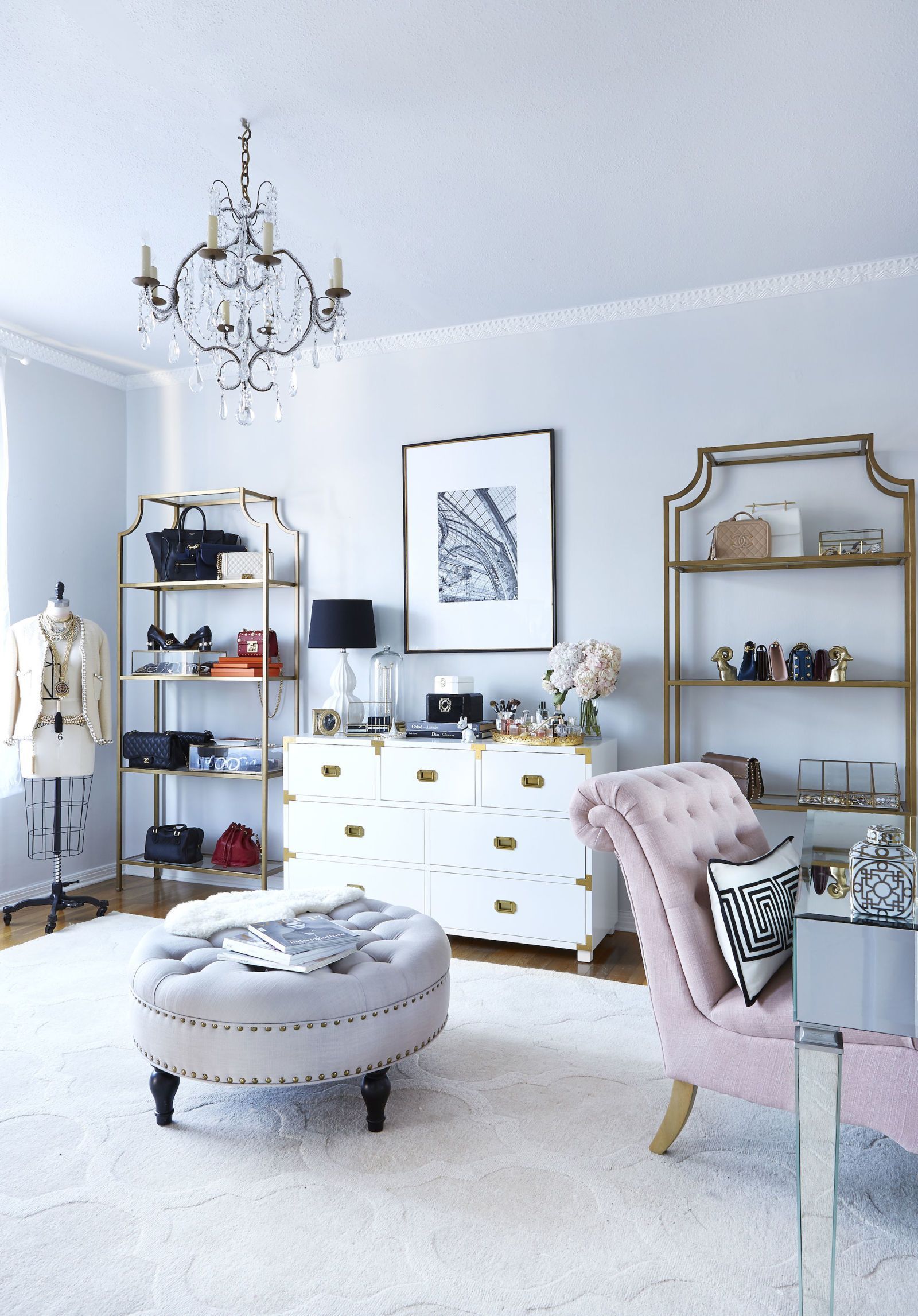 This chic office is inspired by Paris with its white and blush pink tones, statement crystal chandelier and gold accents, but is