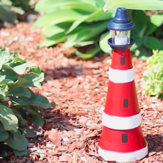 This lighthouse made from terra cotta clay pots is surprisingly easy to assemble, and it even features a lantern on top to cast a