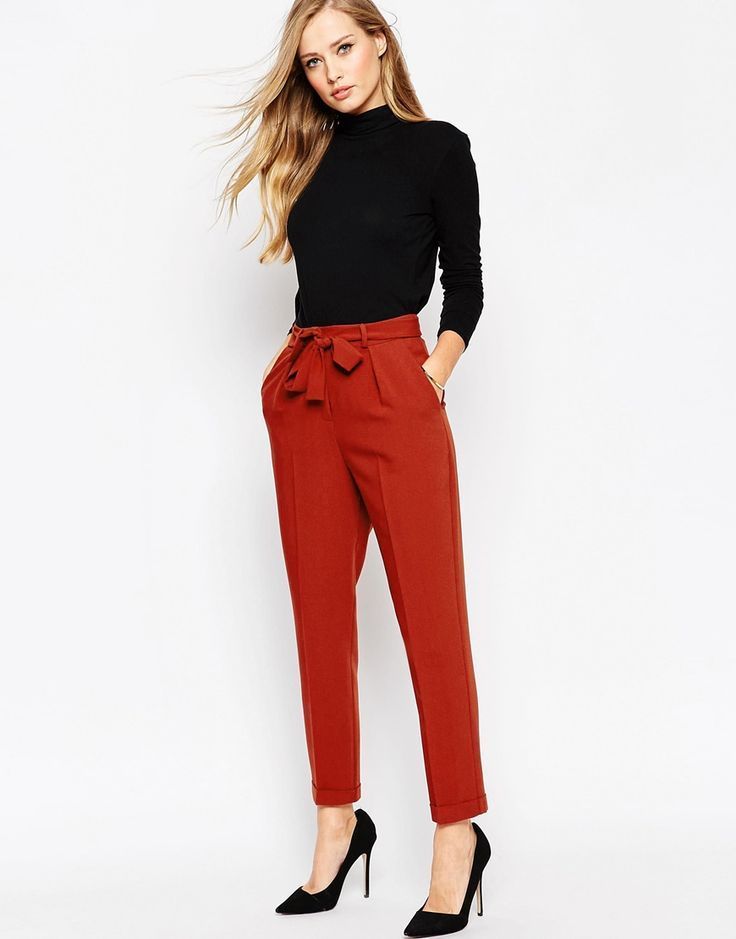 ASOS women’s business casual pants in red with tie around waist. Black high neck sweater.