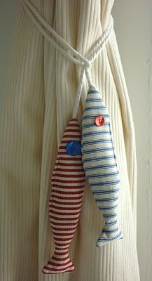 Curtain tiebacks made of ticking fabric, stuffed with lavendar.  Clever idea:  nautical, fish, stripes, curtains