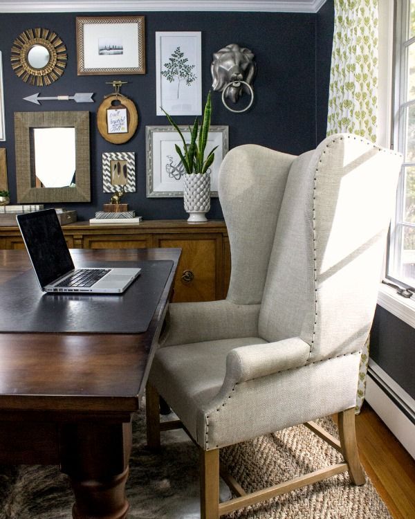 Dramatic dark walls in this home office with large desk and wing back chair eclecticallyvinta…