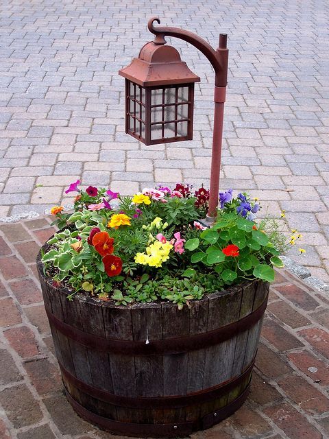 Fill a 1/2 wine barrel with flowers and a lantern – great for a patio