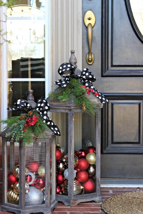 Give your front door the city glam you love by filling lanterns with shiny ornaments, and adorning them with a black and white