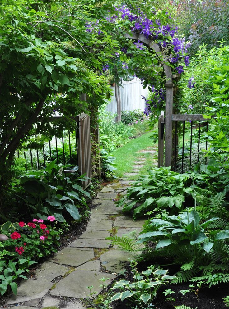 I think all gardens should have some sort of pathway. This is beautiful! Flagstone walkway and arbor.