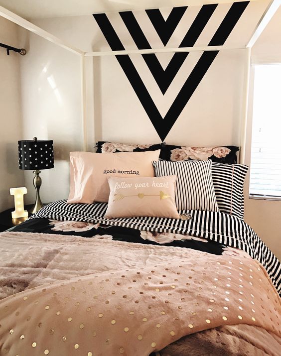 Introduce complimenting colours through furnishing to your B&W bedroom