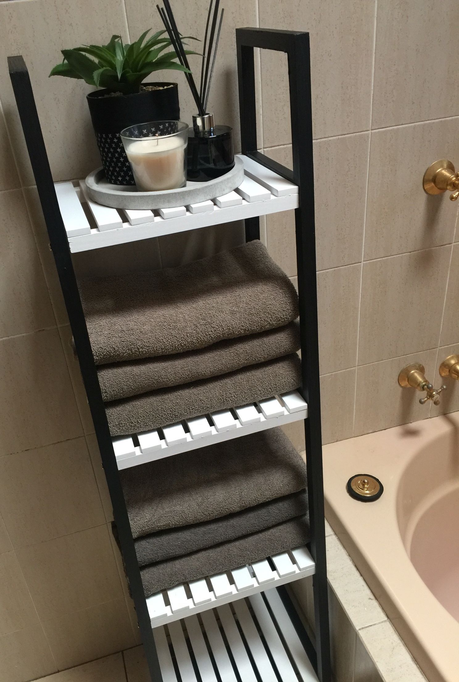 Kmart hack bathroom caddy shelves painted black and white to make it more modern #kmarthack