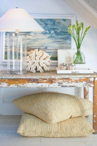 love the coastal style lamp, rustic beachy coir cushions, nautical painting and the pop of color in the flowers, vintage weathered