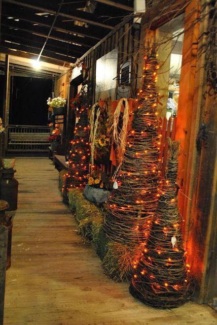 Prim Fall Gathering…lighted grapevine trees on the porch…Olde Mill Primitives.