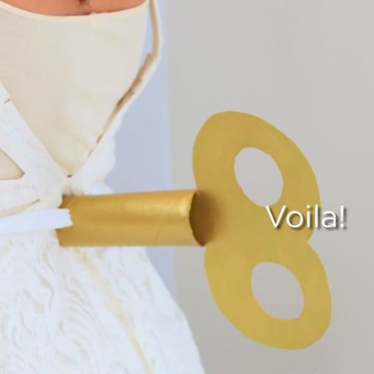 Turn any dress into a doll costume with a wind up key. You can make one with an empty paper towel tube and basic supplies.