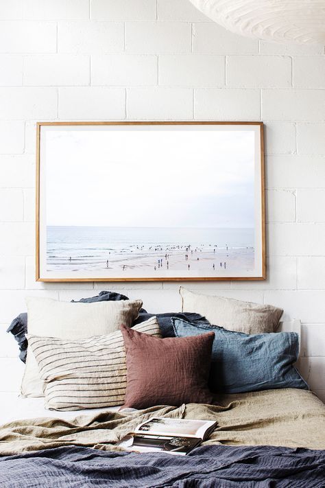 Bedroom inspiration – Lots of neutral pillows, minimalist artwork, and blankets