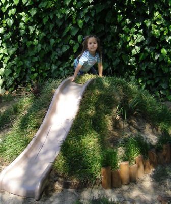 LOVE this slide built in to a small hill. I may need to pitch this idea to Mitch since our swingset is on its last legs.