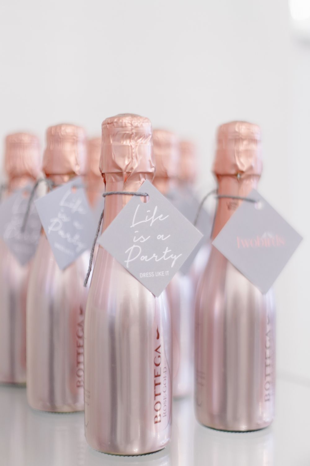 Mini rose gold champagne wedding favours