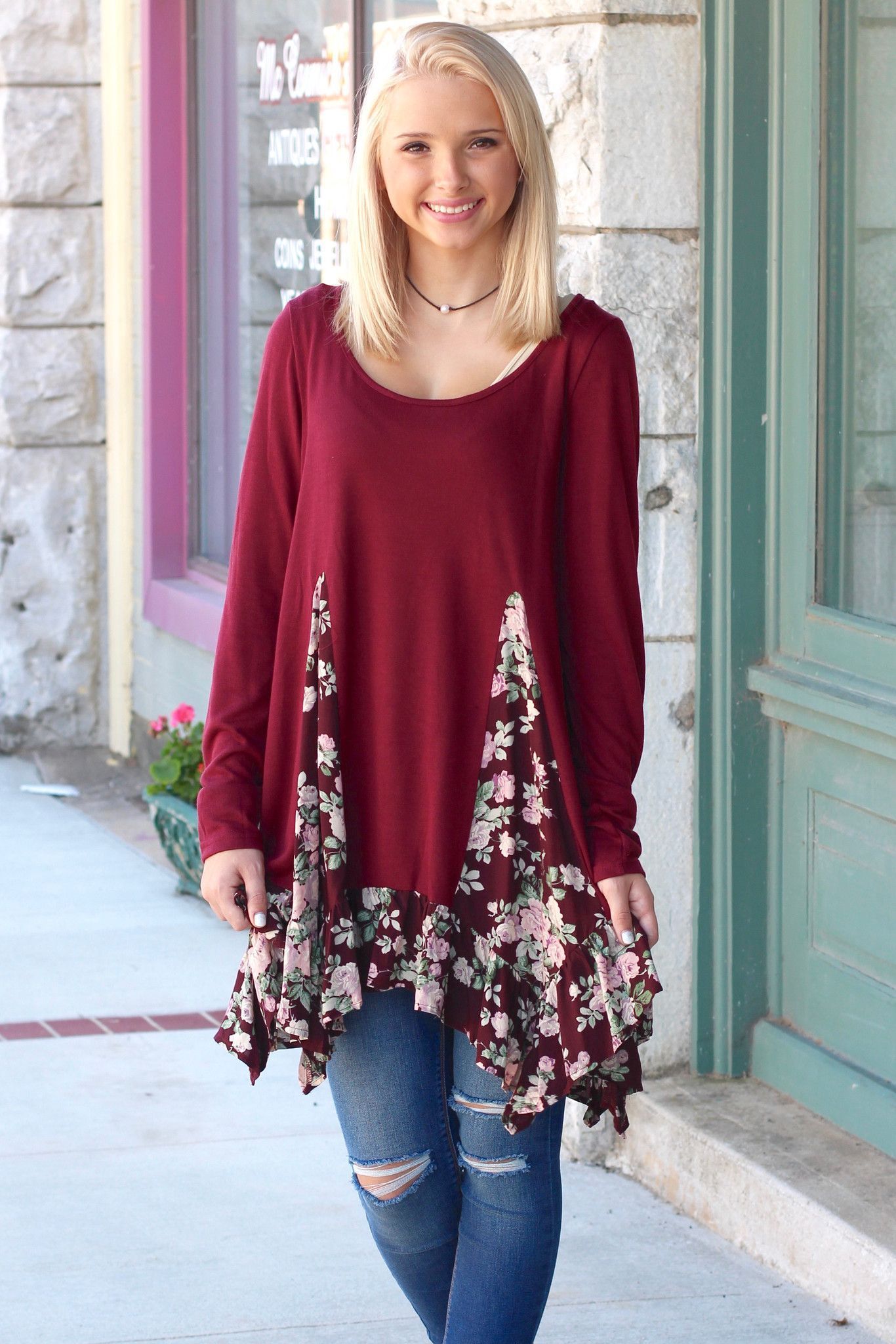 Long sleeve knit tunic top with a rose floral print spliced out of it and ruffled trim!