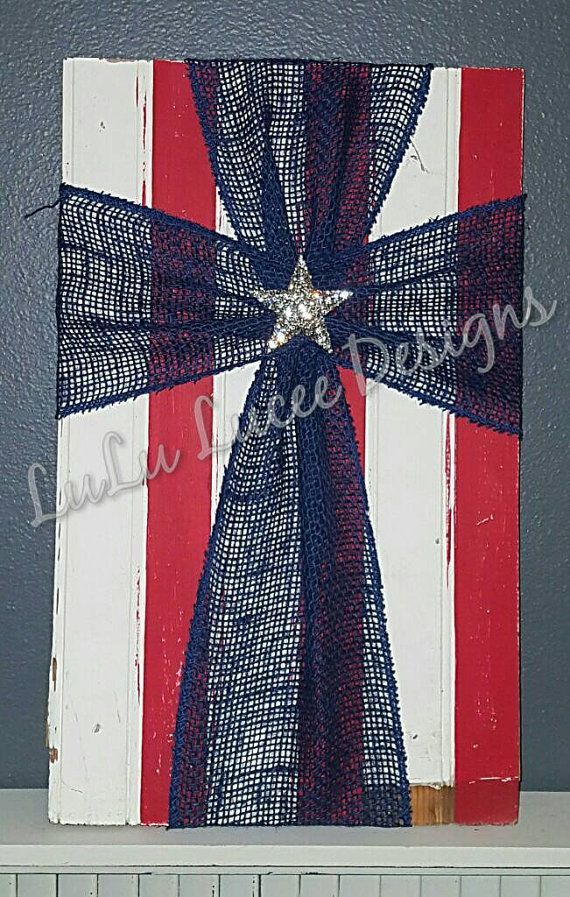 Americana Burlap Cross 10×17 inches Red and white distressed wooden background. Blue Burlap Rhinestone star pendant