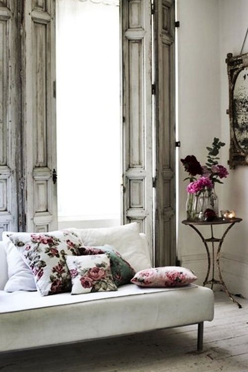 Floral mix and matched pillows in this lovely french bohemian living room