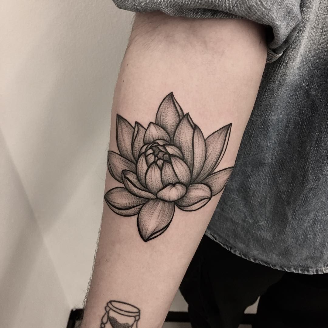 graphic lotus tattoo on forearm