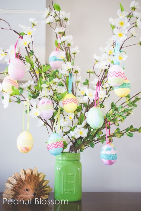 Hang your decorated Easter eggs on a sprigs of silk flowers for a festive “tree.” Get the tutorial at Peanut Blossom.