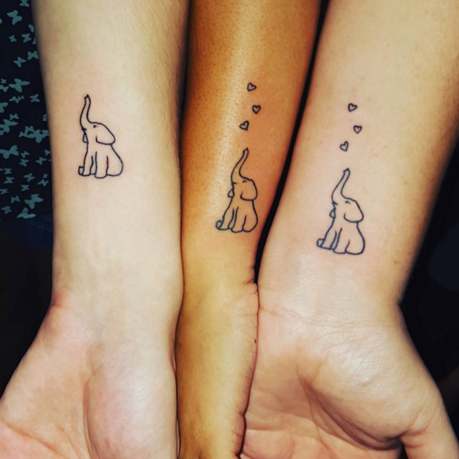 These tiny heart-adorned elephants are a TOO cute idea for a sibling tattoo.