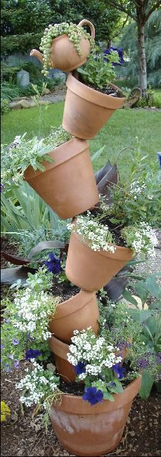 Tipsy Pots : easy to make, just ram a rod of rebar iron into the bottom pot, fill with dirt, and start layering pots through the