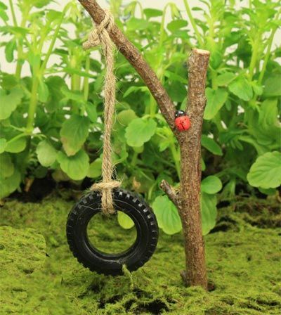 Use a tire from a tractor in the toy aisle!! Miniature tire swing for the fairy garden