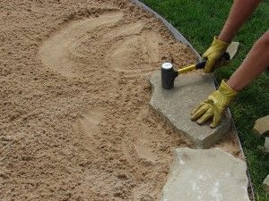 Video and instructions to install a flagstone patio.  This is what I want to do in my back yard… semi circle from our wooden