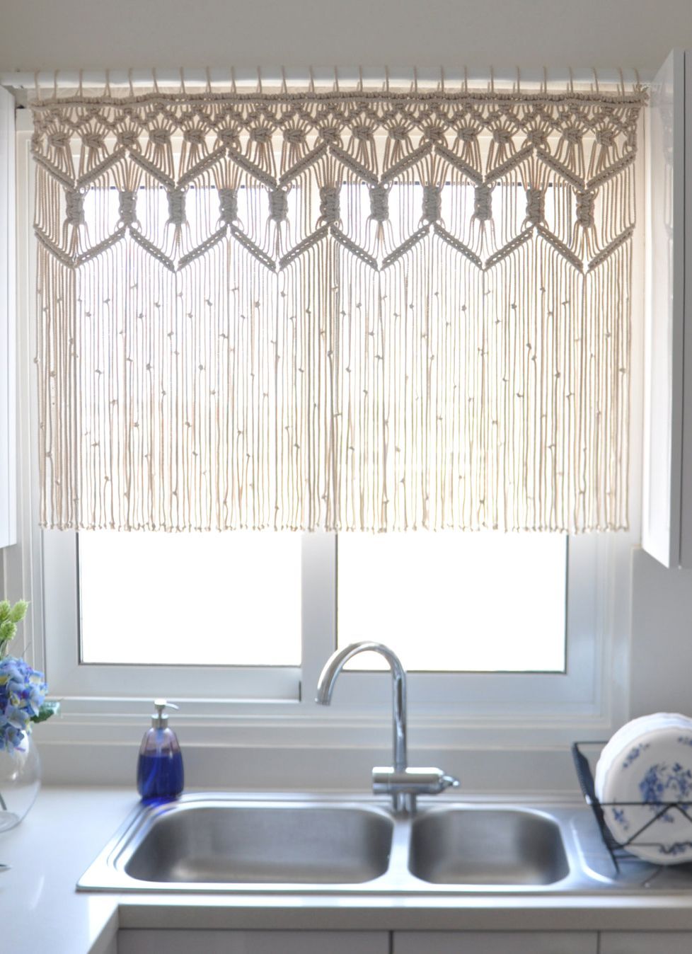 A dreamy macrame curtain is a pleasant addition to washing the dishes