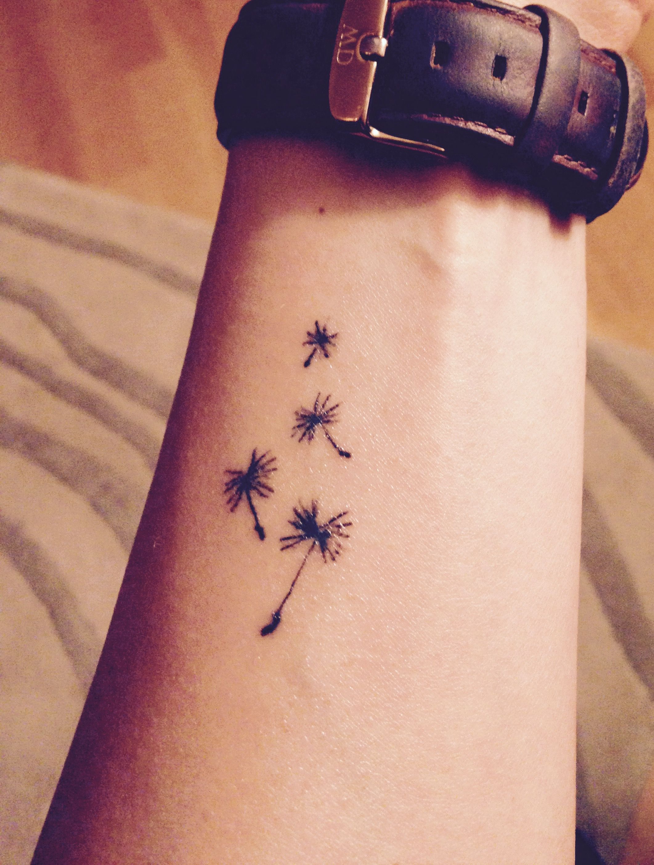 Dandelion tattoo, little seeds flying out of the white puff