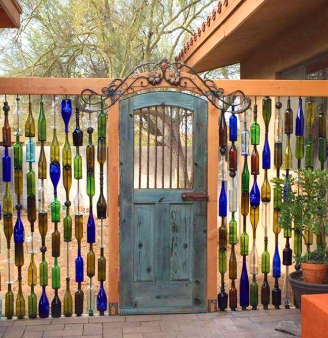DIY Wine Bottle Wall Fence. Beautiful backyard garden inspiration for your home! Creative gates for a gorgeous entryway into a
