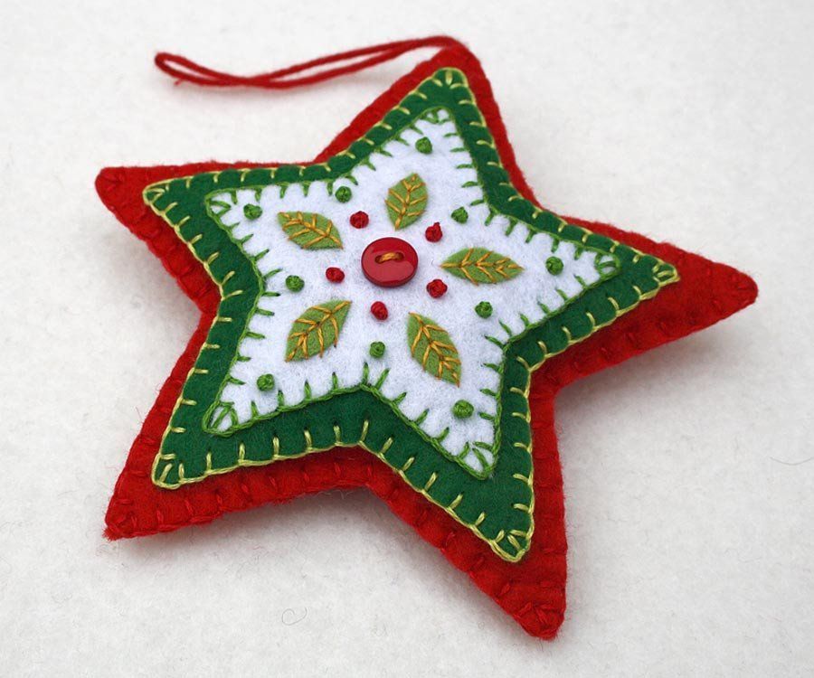 Red and green felt star Christmas ornament. Handmade felt hanging star with embroidered leaves and berries in green white and red,