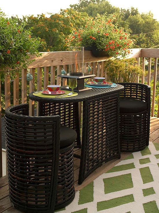 The round chairs tuck beneath the table, disappearing into the oval shape of the synthetic-wicker dining set: