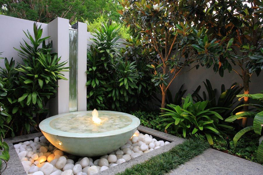 This pondless water feature combined with great night lighting adds  contemporary eutopia to your landscape.