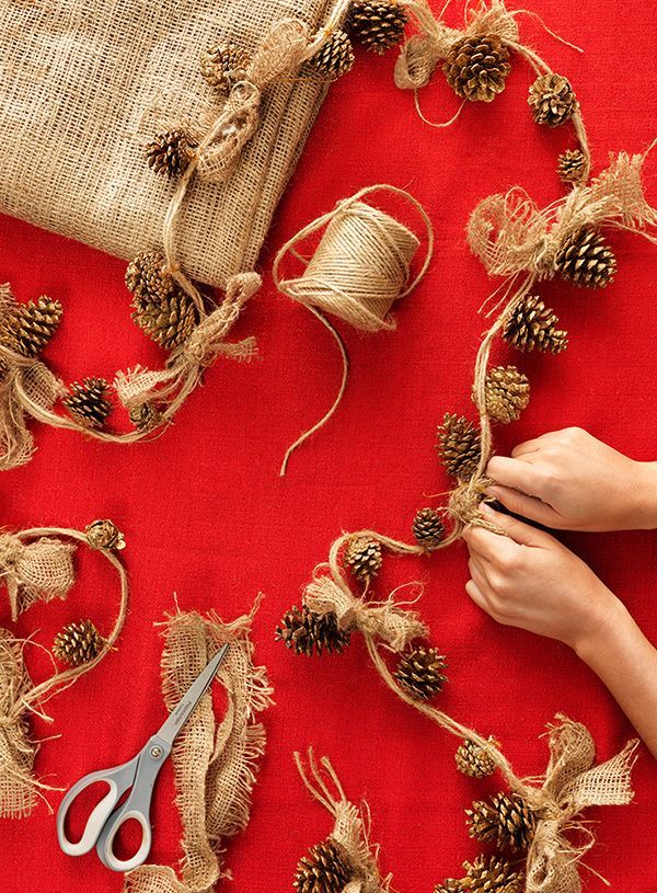 Tie gold-painted pinecone ornaments onto a string of twine, then top each off with a burlap bow for a simple, beautiful holiday
