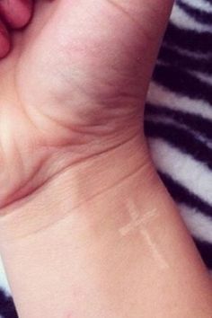 White ink cross tattoo. by lilian. Probably the only tattoo I’d ever get